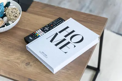 a book sitting on a table with a remote control at Harwich Luxury Suite in Harwich