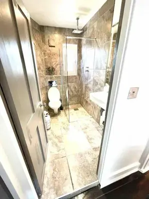 a bathroom with a shower and a toilet and a sink at Historical Police Station Building l Central Cambridge I Park View in Cambridge