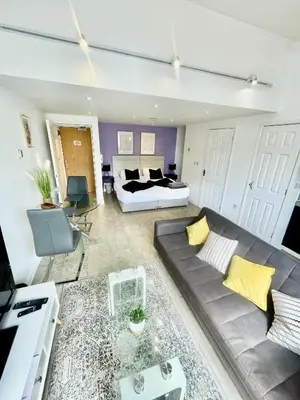 a living room with a couch and a bed at Studio - Sleeps 3 - Parking - Wifi in Cambridge
