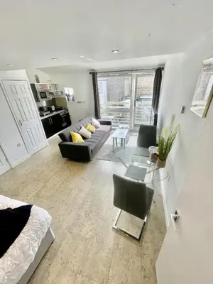 a living room with a couch and a table at Studio - Sleeps 3 - Parking - Wifi in Cambridge