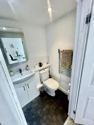 a white bathroom with a toilet and a sink at Studio - Sleeps 3 - Parking - Wifi in Cambridge