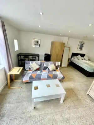 a living room with a couch and a bed at Studio - Sleeps 2 - Parking - Wifi in Cambridge