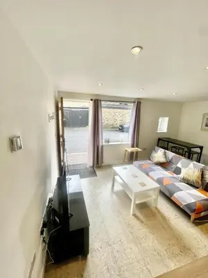 a living room with a couch and a table at Studio - Sleeps 2 - Parking - Wifi in Cambridge