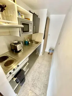 a small kitchen with a sink and a microwave at Studio - Sleeps 2 - Parking - Wifi in Cambridge