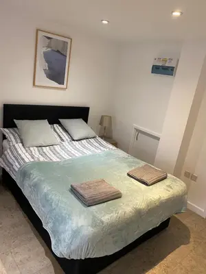 a bedroom with a bed with two towels on it at Studio - Sleeps 2 - Parking - Wifi in Cambridge