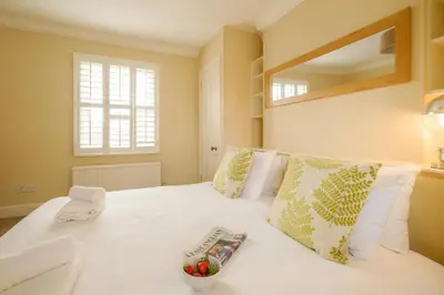 a bedroom with a large white bed with pillows at Tanyard House in Woodbridge