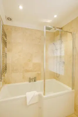 a bathroom with a bath tub and a shower at Tanyard House in Woodbridge