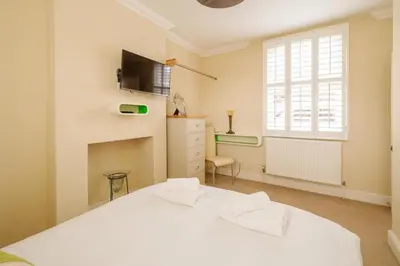 a bedroom with a white bed and a window at Tanyard House in Woodbridge