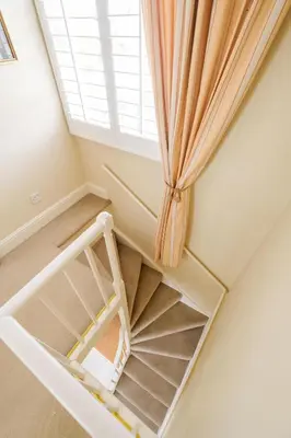 a staircase in a room with a window at Tanyard House in Woodbridge