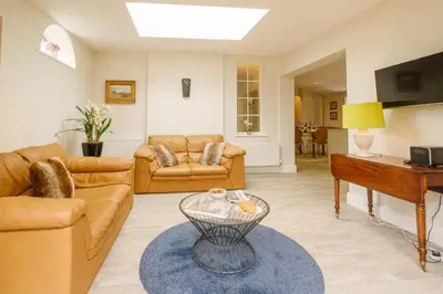 a living room with a couch and a table at Tanyard House in Woodbridge