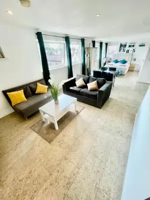 a living room with two couches and a table at City Centre Cozy Studio flat Second Floor in Cambridge