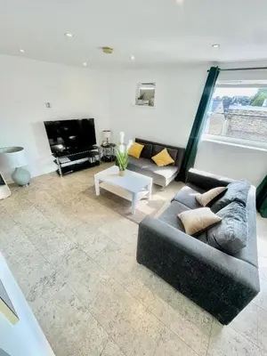 a living room with a couch and a tv at City Centre Cozy Studio flat Second Floor in Cambridge