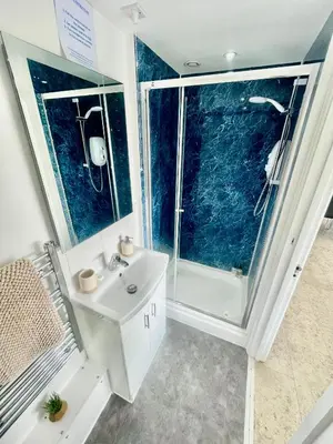a bathroom with a white sink and a shower at City Centre Cozy Studio flat Second Floor in Cambridge