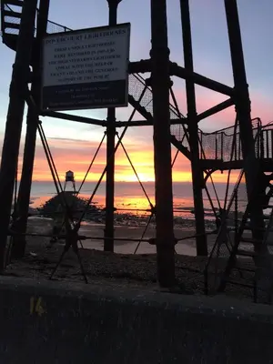 a sign on a roller coaster with a sunset in the background at AcLand Lodge Dovercourt West in Harwich