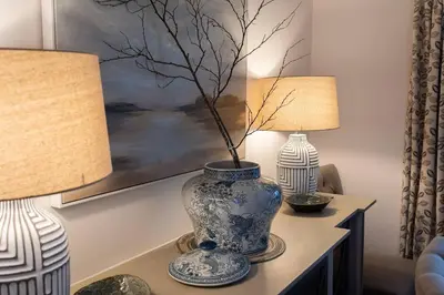 a blue and white vase on a table with two lamps at Charming 4 Bed Cottage in Herts Countryside - Pass the Keys in Sacomb