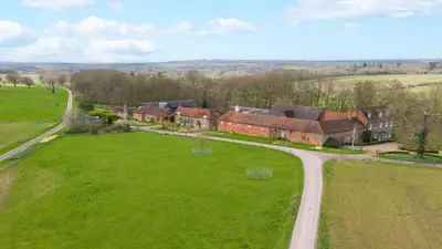 an aerial view of a house in a green field at Charming 4 Bed Cottage in Herts Countryside - Pass the Keys in Sacomb