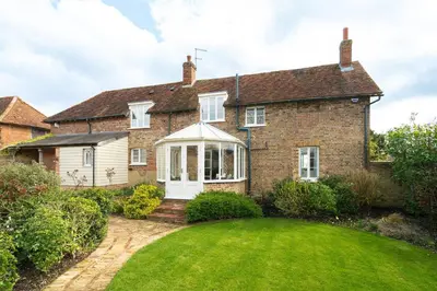 an old brick house with a lawn in front of it at Charming 4 Bed Cottage in Herts Countryside - Pass the Keys in Sacomb