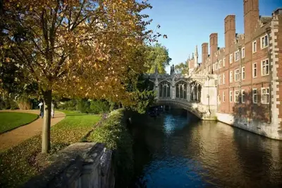 a bridge over a river in front of a building at Pass the Keys Central Modern Cabin on Mill Road in Cambridge