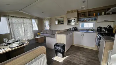 a kitchen and living room in a caravan at Pura Vida Caravan in Saint Osyth
