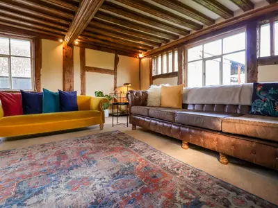 a living room with two couches and a rug at Brook Farm in Harleston