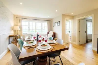 a dining room with a table and chairs at 9 The Haven in Thorpeness