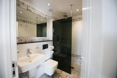 a bathroom with a sink and a toilet and a shower at Great Blunts Stables - Stock Brook Manor Golf Club in Billericay