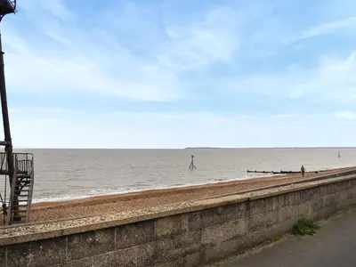 a view of a beach with a person walking in the water at Swift Johnson in Dovercourt