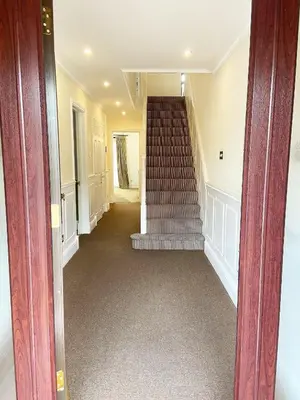 a hallway with a staircase in a house at Emerson Park Mansion in Harold Wood