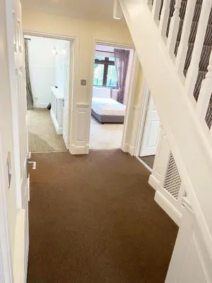a hallway with a staircase leading to a bedroom at Emerson Park Mansion in Harold Wood