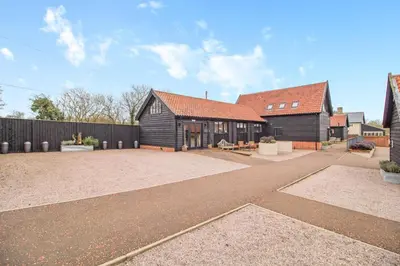 a home with a black building and a fence at 2 Bed in Heveningham oc-w29033 in Heveningham