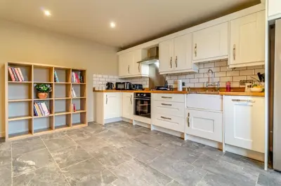 a kitchen with white cabinets and a tile floor at 2 Bed in Heveningham oc-w29035 in Heveningham