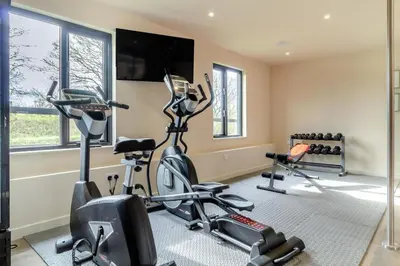 a gym with two exercise bikes and a flat screen tv at 3 Bed in Heveningham oc-w29030 in Heveningham