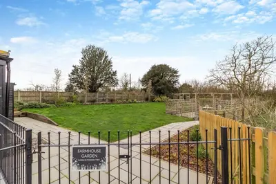 a gate with a sign in front of a garden at 3 Bed in Heveningham oc-w29030 in Heveningham