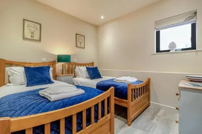 a bedroom with two beds and a window at 3 Bed in Heveningham oc-w29030 in Heveningham
