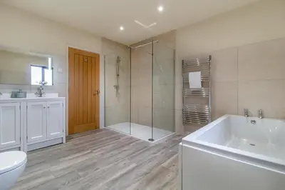 a bathroom with a tub and a shower and a toilet at 1 Bed in Heveningham oc-w29032 in Heveningham