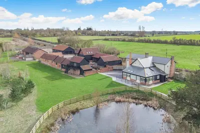an aerial view of a house with a pond at 2 Bed in Heveningham oc-w29029 in Heveningham