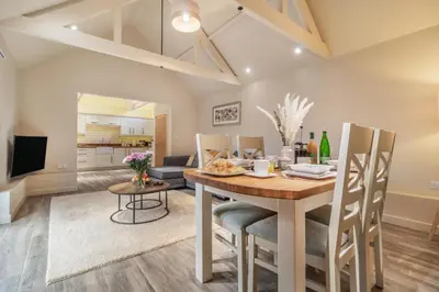a dining room and living room with a table and chairs at 2 Bed in Heveningham oc-w29029 in Heveningham