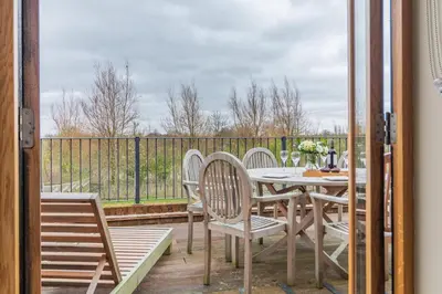 a patio with a table and chairs on a deck at 4 Bed in Heveningham oc-w29036 in Heveningham