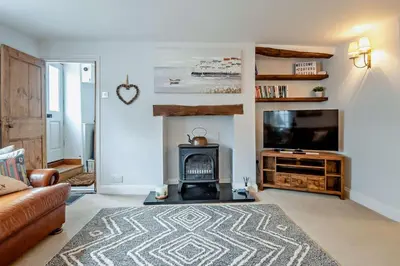 a living room with a fireplace and a television at 3 Bed in Aldeburgh oc-o5630 in Aldeburgh