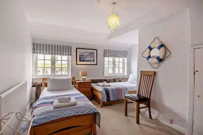a bedroom with two beds and a desk and a chair at 3 Bed in Aldeburgh oc-o5630 in Aldeburgh