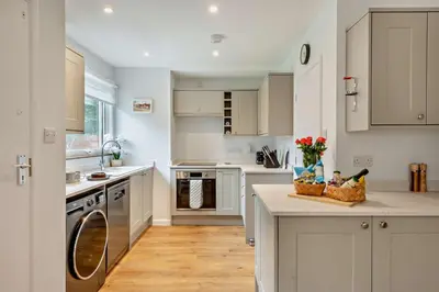 a kitchen with white cabinets and a counter top at 3 Bed in Acton oc-c28929 in Great Waldingfield