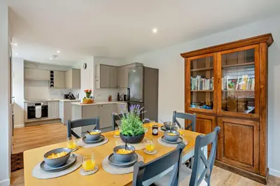 a kitchen and dining room with a table and chairs at 3 Bed in Acton oc-c28929 in Great Waldingfield