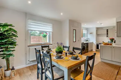 a kitchen and dining room with a table and chairs at 3 Bed in Acton oc-c28929 in Great Waldingfield