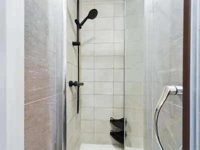 a bathroom with a shower with a glass door at Cosy Modern Apartment Colchester in Colchester