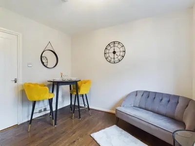 a living room with a couch and a table at Cosy Modern Apartment Colchester in Colchester