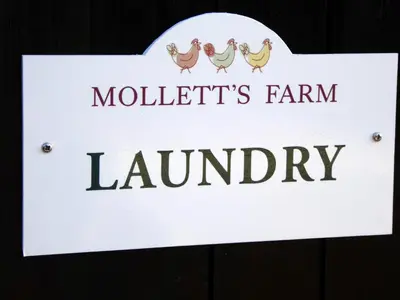 a sign for a farm library with chickens on it at Mollett's Farm in Saxmundham