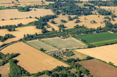 an aerial view of a farm with fields and trees at Mollett's Farm in Saxmundham