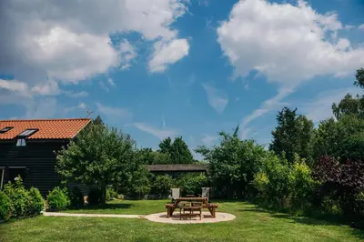 a picnic table and bench in a yard at Mollett's Farm in Saxmundham