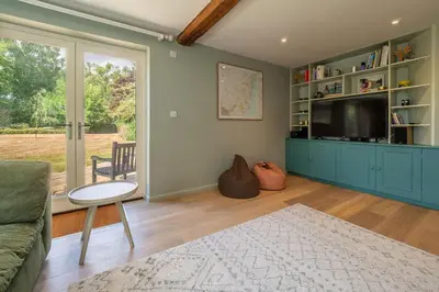 a living room with a couch and a tv at Foxhole Cottage 8 in Stowmarket