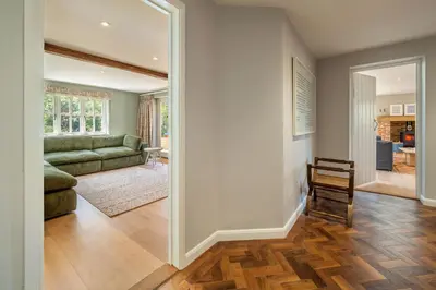 a living room with a couch and a table at Foxhole Cottage 10 in Stowmarket